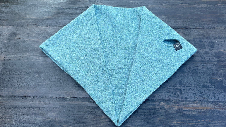 Solid light-blue double-layer wool kerchief with pull-through opening, flat lay