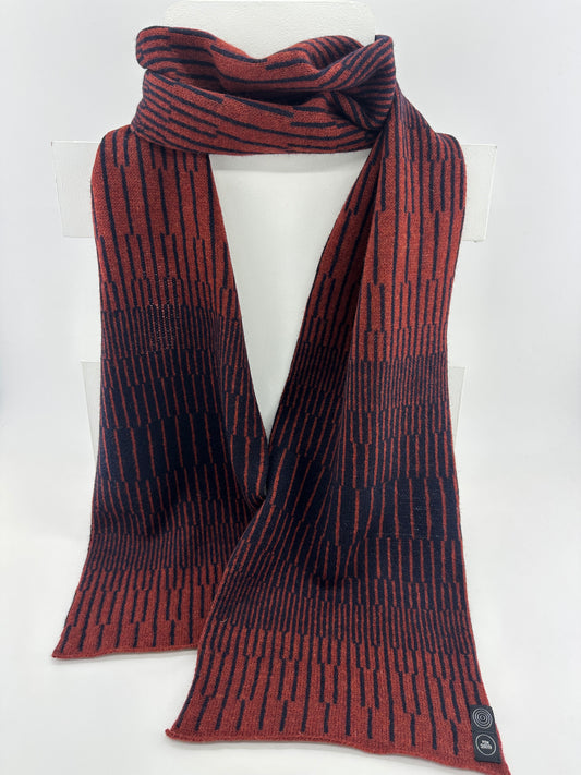 Sienna Brown and Navy Blue handcrafted merino Lambswool striped Reverb Scarf hanging on a white display stand  against a neutral background. Pom Shanty Knitwear.