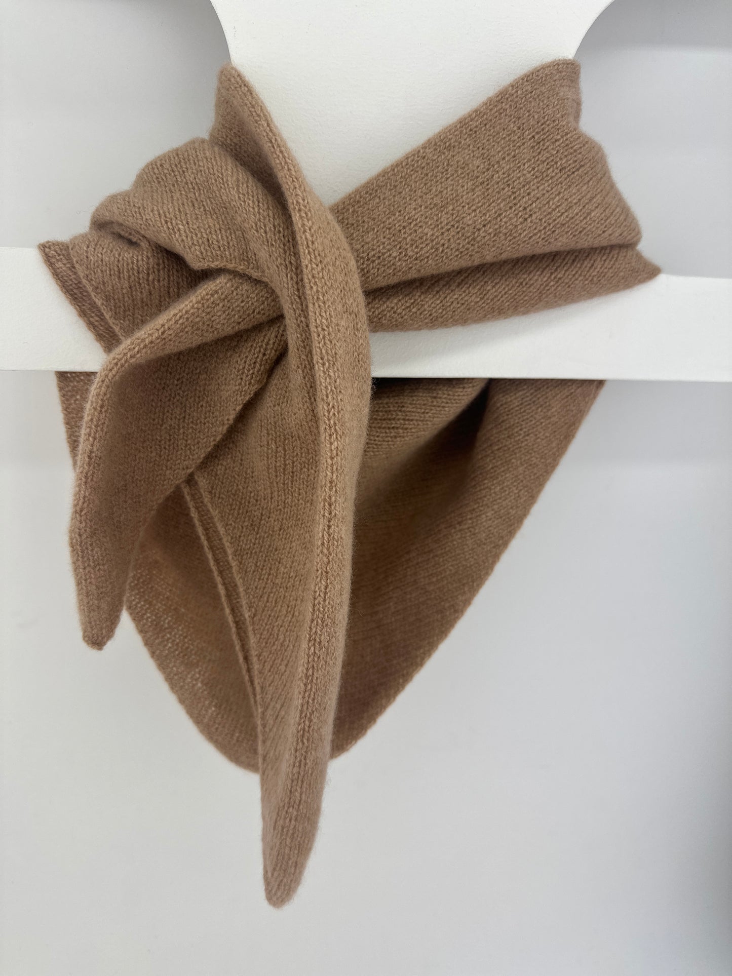 merino lambswool double layer solid colour, camel brown pull through triangle scarf / kerchief / neckerchief for women, men, unisex hanging from a white hanger on a neutral background