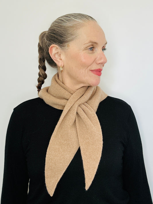 Beautiful sexy woman in a black top with her hari tied back and red lipstick on wearing merino lambswool double layer solid colour, camel brown pull through triangle scarf / kerchief / neckerchief for women, men, unisex