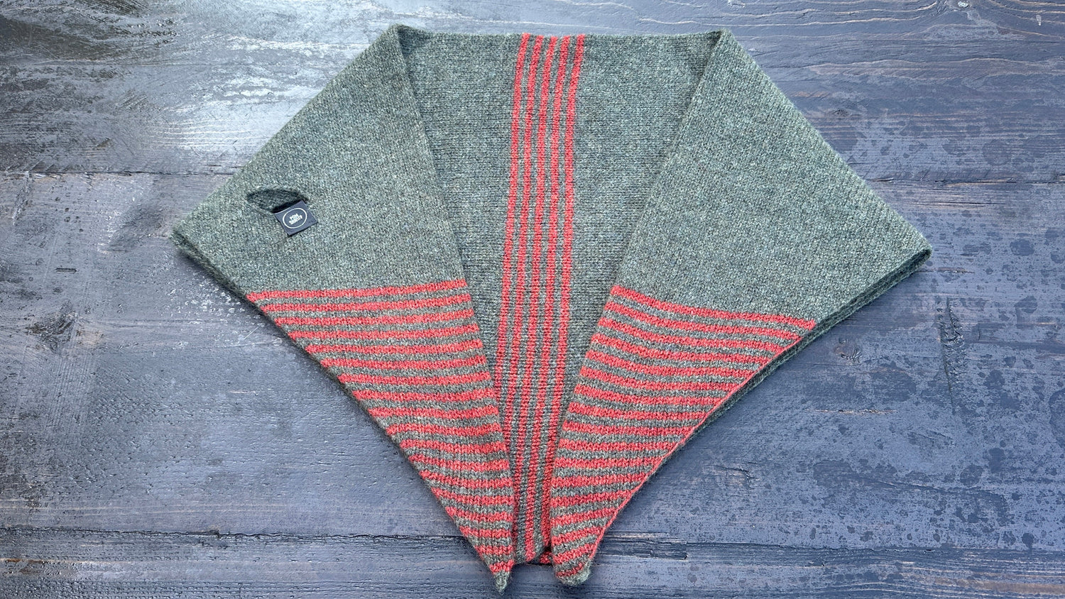 Olive merino wool kerchief with sienna stripes and pull-through opening, flat lay