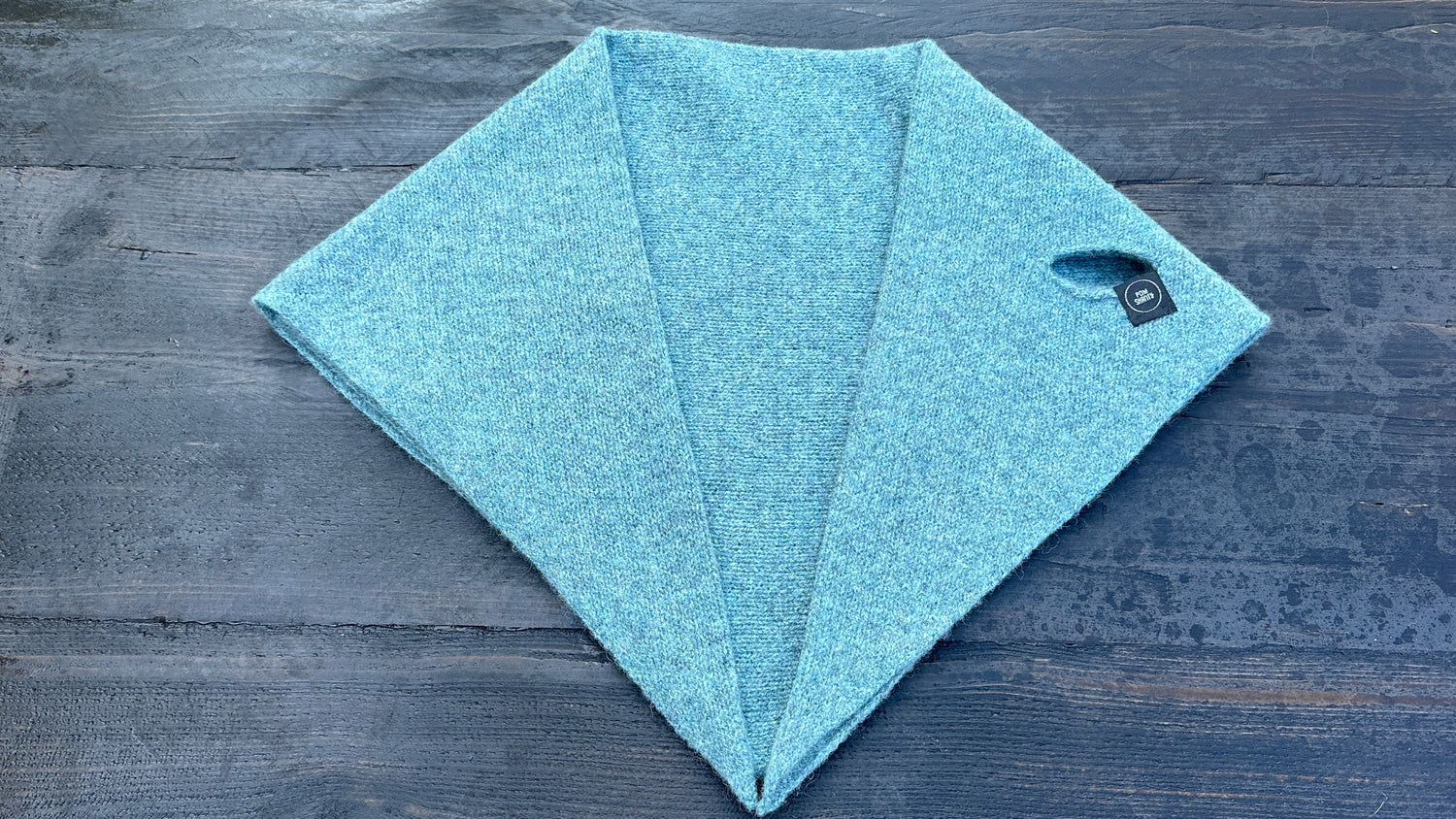Solid light-blue double-layer wool kerchief with pull-through opening, flat lay