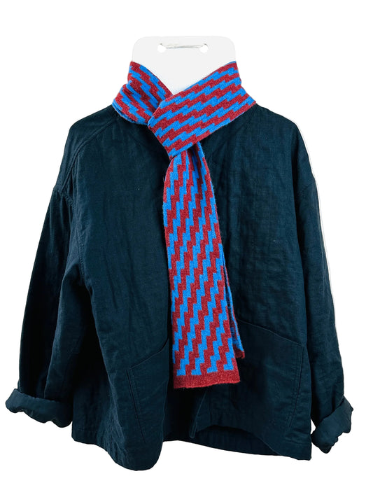 Cornflower Blue & Sienna Brown Rick Rack Skinny Scarf, lambswool, draped over a black jacket