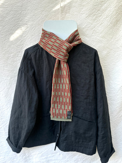 Olive and Sienna Brown Rain Skinny Scarf, lambswool, draped over a black jacket