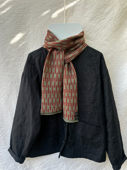 Olive and Sienna Brown Rain Skinny Scarf, lambswool, draped over a black jacket
