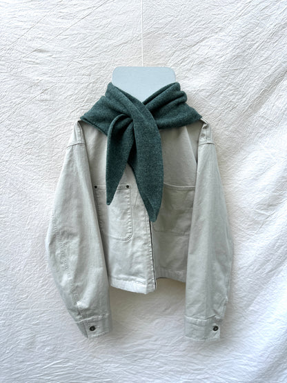 Peacock Green Triangle Scarf, merino wool, draped over a cream jacket