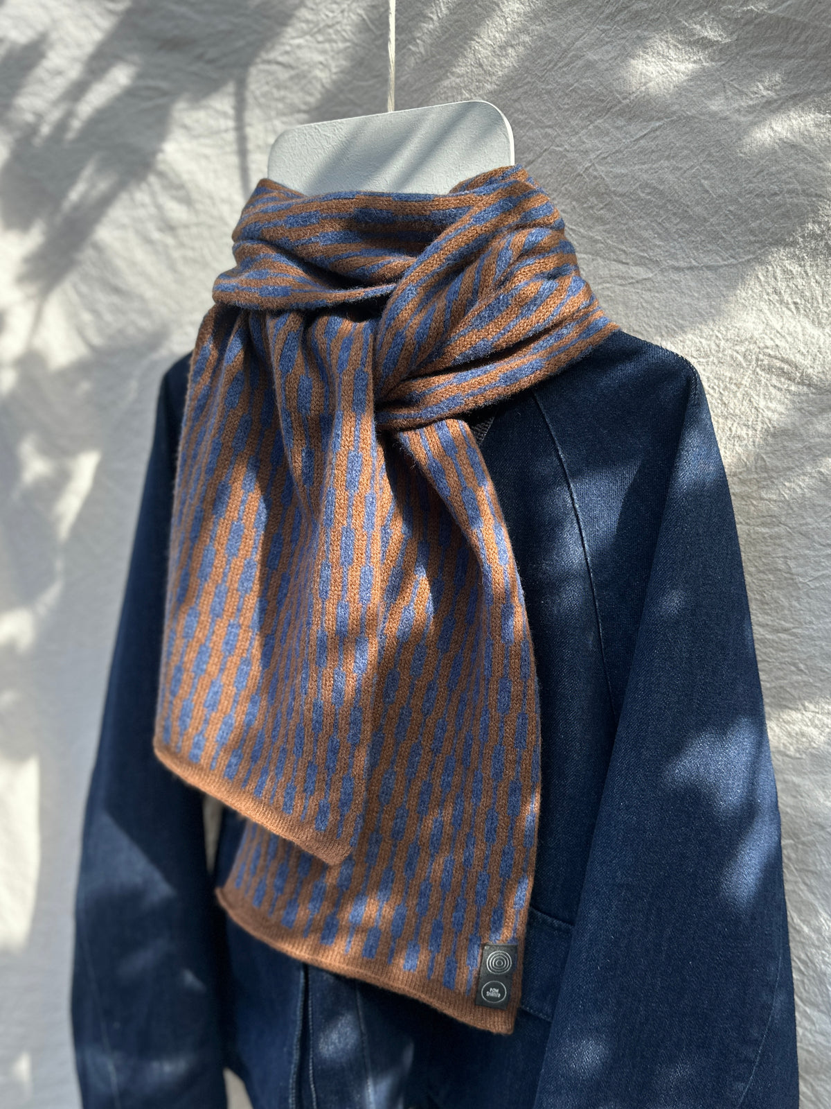 Rhapsody Blue and Spaniel Brown Cascade Scarf, lambswool, draped over a denim jacket